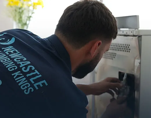 Gas fitter checking an oven connection